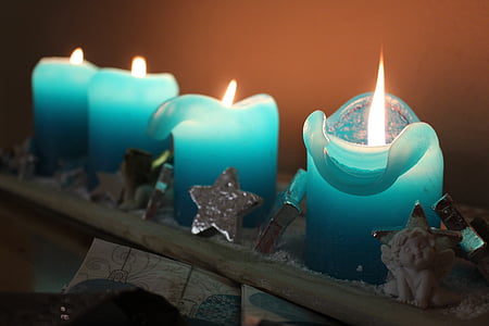 time lapse photography of four blue lighted candles thumbnail