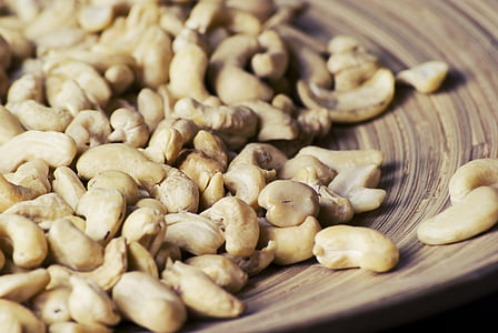 bunch of cashew nuts on brown plate thumbnail
