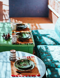 green ceramic saucer on brown knitted table mat thumbnail