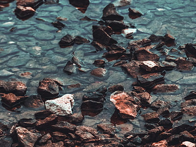 black stone fragments on body of water during daytime thumbnail