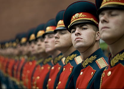 Men in Black and Red Cade Hats and Military Uniform thumbnail