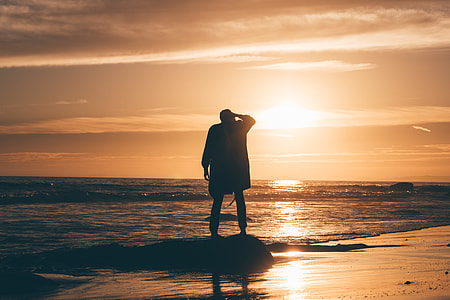 silhouette of man near the ocean thumbnail