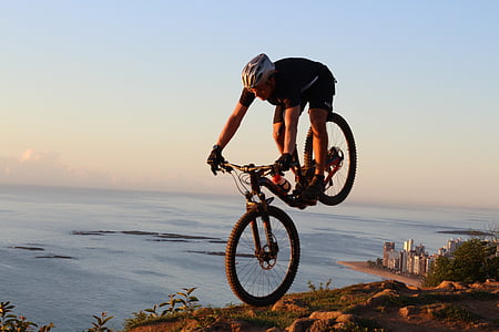 man biking on rocky terrain during golden hours thumbnail