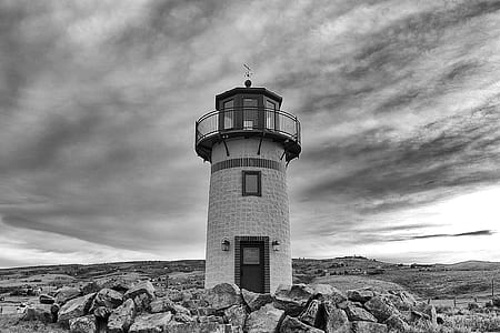 grayscale lighthouse during cloudy daytime thumbnail