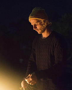 Man Wearing Black Sweater and Holding Rope thumbnail