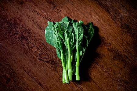 green bok choy on brown wood surface thumbnail