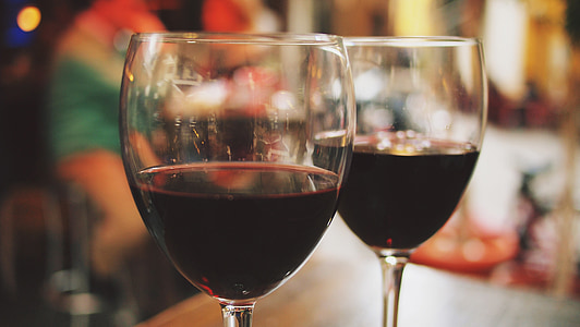 clear wine glasses filled with red wines thumbnail