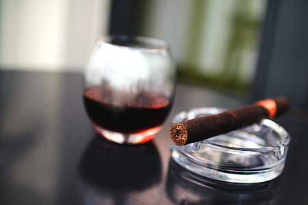 cigarette on ashtray near drinking glass thumbnail
