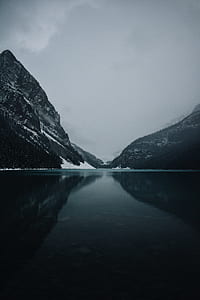 calm body of water near mountain thumbnail