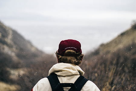 man standing near mountain cliff thumbnail