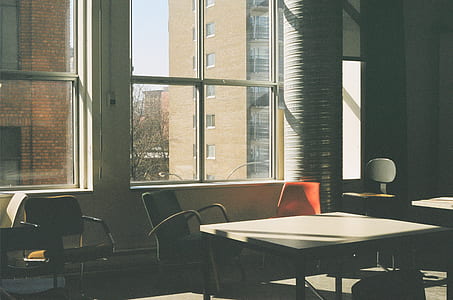 rectangular table and swivel chairs near window thumbnail