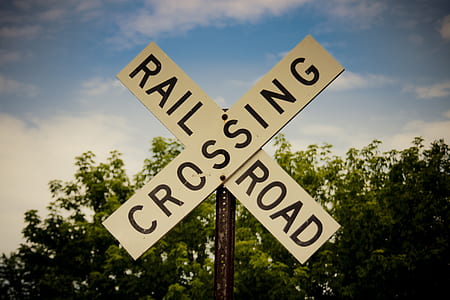 rail crossing road signage near tree thumbnail