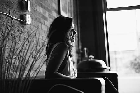 greyscale photography of woman sitting on the sofa thumbnail
