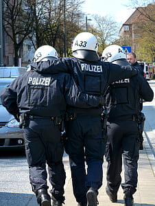 policeman being carried by other two officers at sidewalk thumbnail