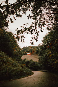photo of orange 2-storey building near trees under cloudy sky thumbnail