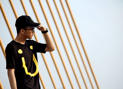 man wearing black crew-neck shirt covering his eyes looking faraway thumbnail