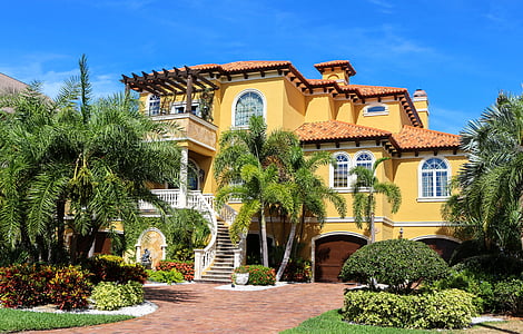 yellow painted house during daytime thumbnail