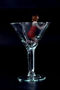 woman wearing red sleeveless dress in clear cocktail glass thumbnail