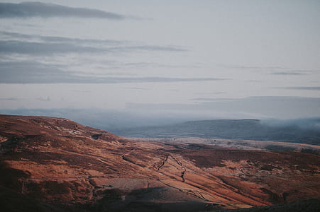 brown mountain under gray clouds thumbnail