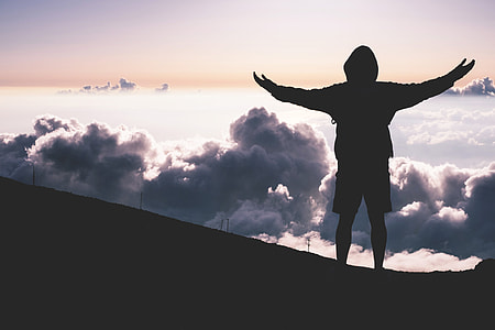 Man standing in mountain clouds thumbnail