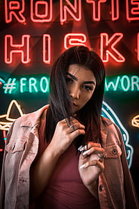 woman standing near neon signage thumbnail