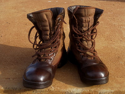 brown leather combat boots on brown concrete surface thumbnail