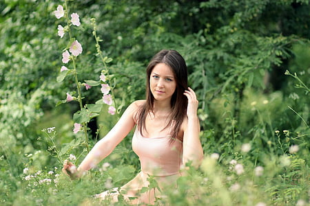 woman hand on hair beside flowers thumbnail