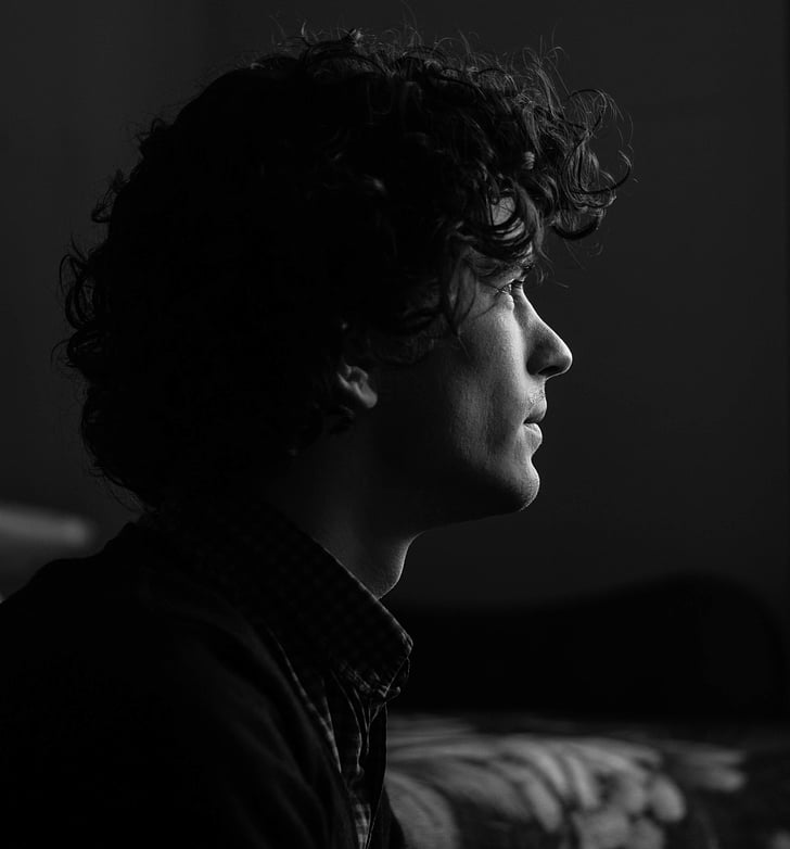 grayscale of man facing left