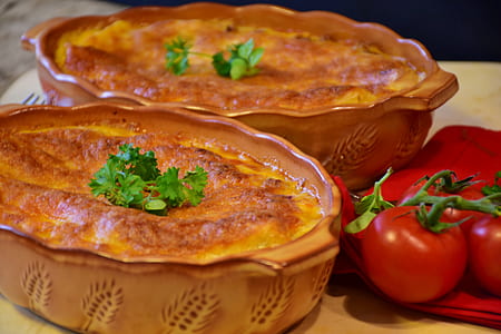 two baked pies served on beige ceramic trays thumbnail