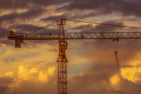 brown metal crane under grey sky thumbnail