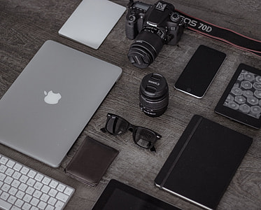 flat lay photography of MacBook, camera, and sunglasses thumbnail