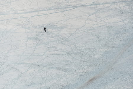 person walking on white pavement at daytime thumbnail