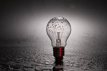 clear light bulb on gray surface with water droplets thumbnail
