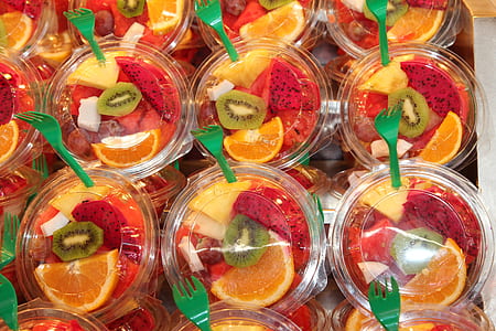 close-up photo of sliced fruits in plastic case with forks thumbnail