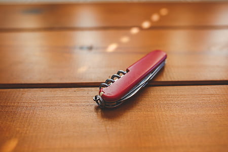 Red closed penknife on the desk thumbnail