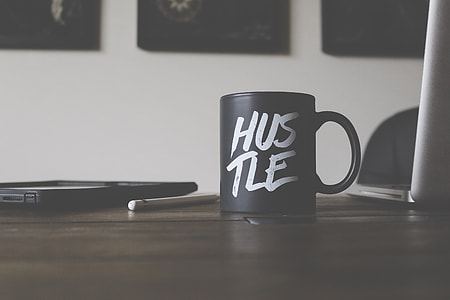 black Hustle ceramic mug on brown wooden top thumbnail