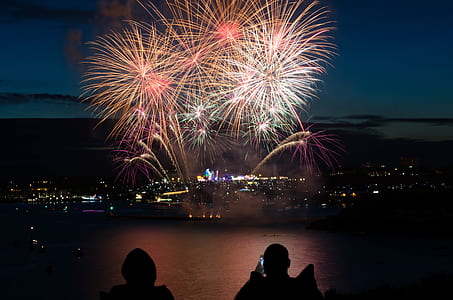 silhouette of two persons watching fireworks during night thumbnail