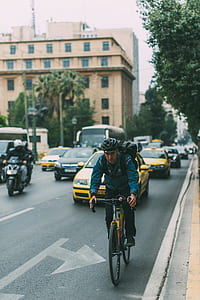 man riding bicycle on pavement thumbnail