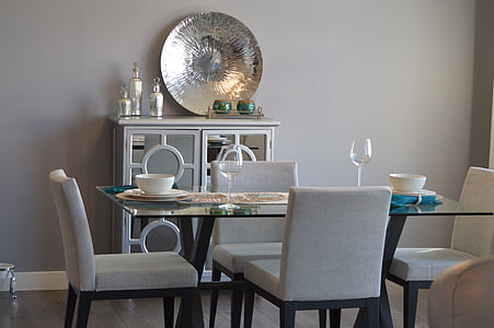 rectangular clear glass-top wooden base table surrounded by white parson chairs thumbnail