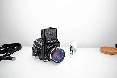 black Mamiya land camera beside black strap thumbnail