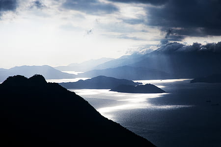 wide angle photo of body of water under cloudy sky thumbnail