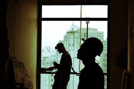 man standing near window thumbnail