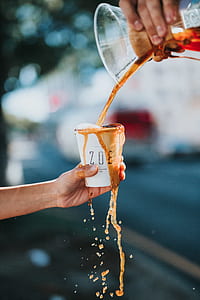 person holding zoe cup filled with substance thumbnail