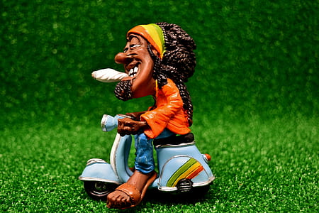 Rasta Man riding motor scooter figurine thumbnail