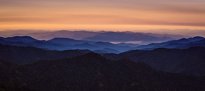 silhouette photo of mountains during golder hour thumbnail