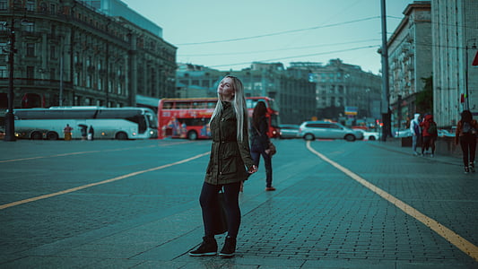 woman standing beside road near people passing by thumbnail