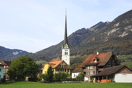 church across green grass field thumbnail