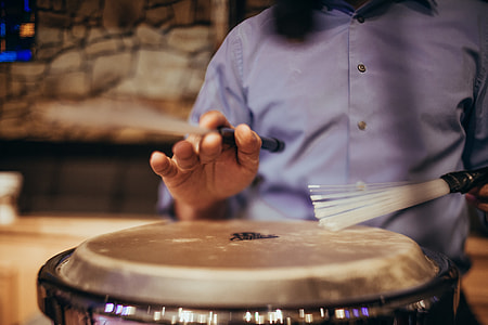 man playing drums in close-up photography thumbnail