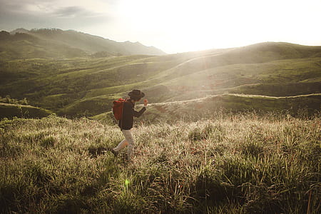 man walking on grass field thumbnail