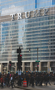 crowd of people walking outside Trump curtain wall building thumbnail